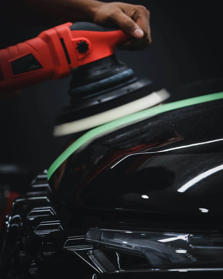 Rotary buffer polishing car paintwork during detailing