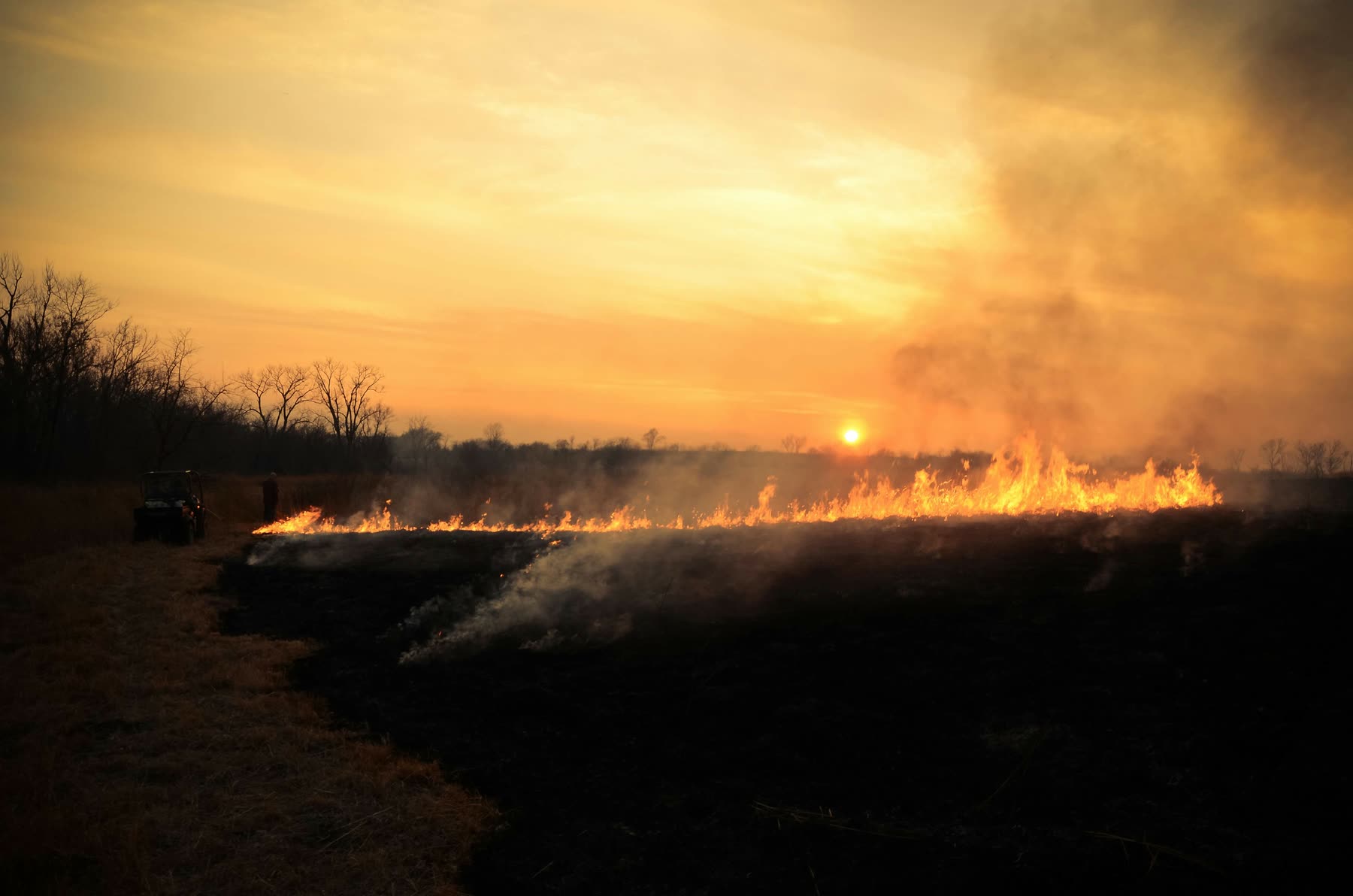 Grassland fire at sunset